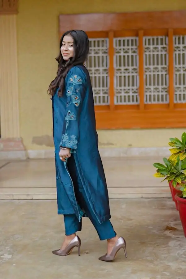 Model styling Teal Blossom Ladies Dress in full outfit with accessories, from Saanah ladies clothing collection.