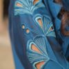 Close-up of Teal Blossom Ladies Dress on model, focusing on floral embroidery details, from Saanah traditional wear collection.