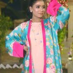 Front view of a woman in the Saanah Blossom Breeze Silk Shrug Set, showcasing a peach blush cami and culottes with a teal floral shrug.