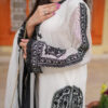 Model in Shan-e-Zar: White Elegance Unleashed, displaying side profile with intricate white traditional dress details, from Saanah ladies clothing.