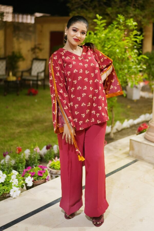 Close-up of the floral-patterned sleeves on the Saanah Maroon Elegance Tailored Coord Set, showcasing orange detailing on a maroon background.