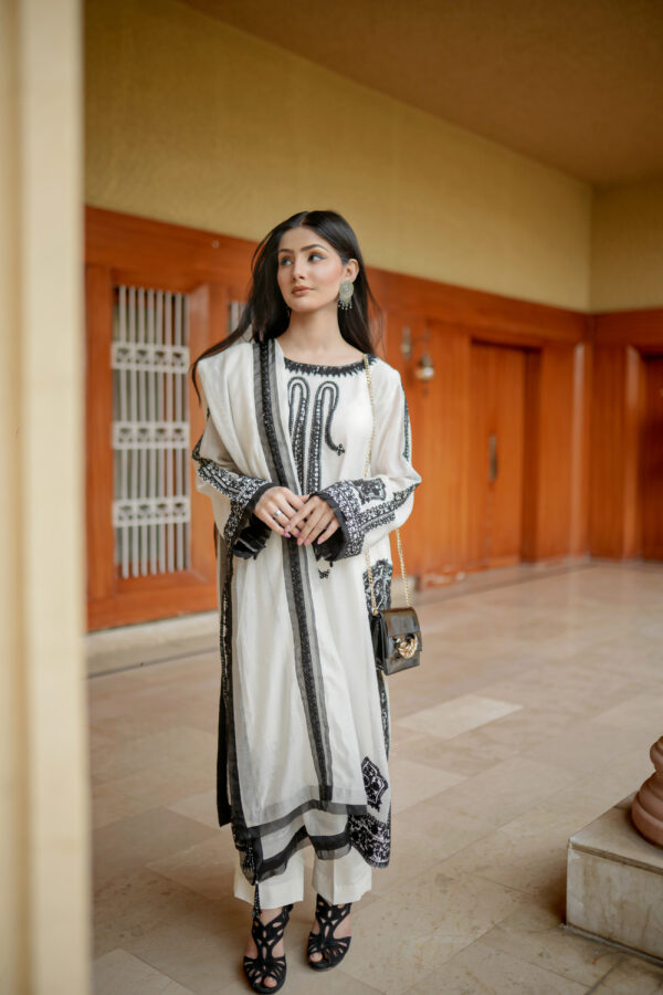 Model in Shan-e-Zar: White Elegance Unleashed, styled for a festive look with white traditional dress, from Saanah collection.