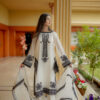 Model wearing Shan-e-Zar: White Elegance Unleashed, showcasing front view with floral embroidery, from Saanah traditional clothing collection.