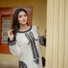Model posing elegantly in Shan-e-Zar: White Elegance Unleashed, a white traditional dress, from Saanah traditional clothing collection.