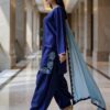 Side profile showing embroidered hem and scalloped medium silk dupatta.