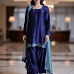 Front view of royal blue kurta with embroidered daman and silk dupatta.