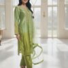 Side profile showing scalloped embroidered daman and sheer organza dupatta with tassels.