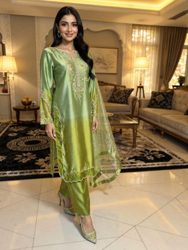 Elegant two-tone apple green pure sheesha silk suit with heavy hand embroidery.