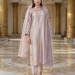 Elegant powder pink sheesha silk suit with heavy embroidery on the shirt.